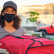 delivery driver holding pizza bag